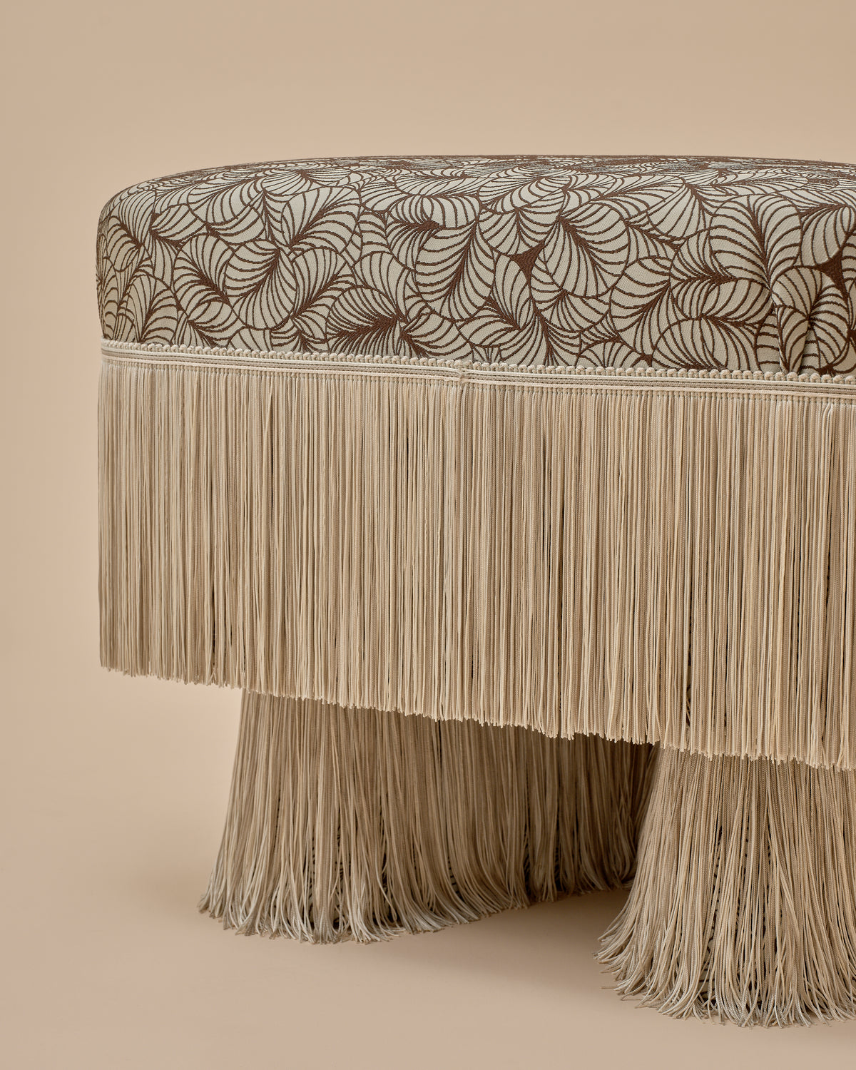 Deco Fan Jacquard in Mint by Spencer Malinski with sage ombre fringe, detail of the Nerova Ottoman by Love House x Spencer Malinski, available at Love House New York