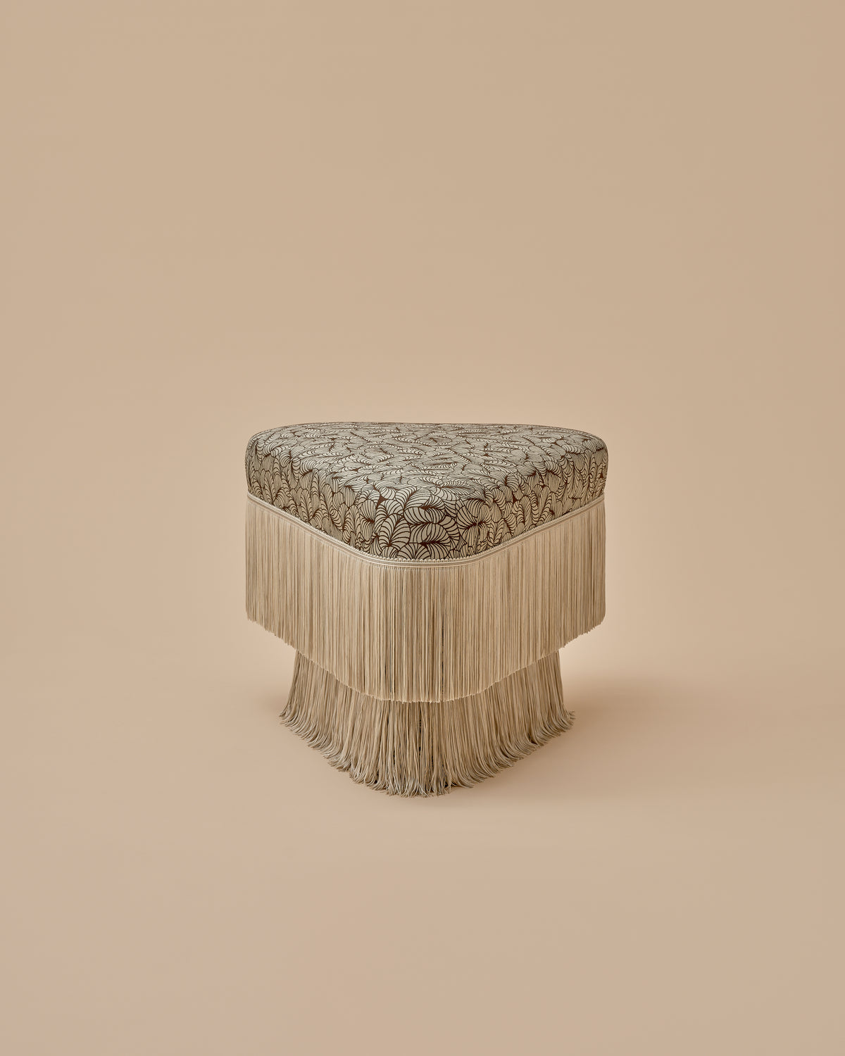 Nerova Ottoman by Love House x Spencer Malinski, corner view of the rounded triangular seat and tiered fringe, available at Love House New York